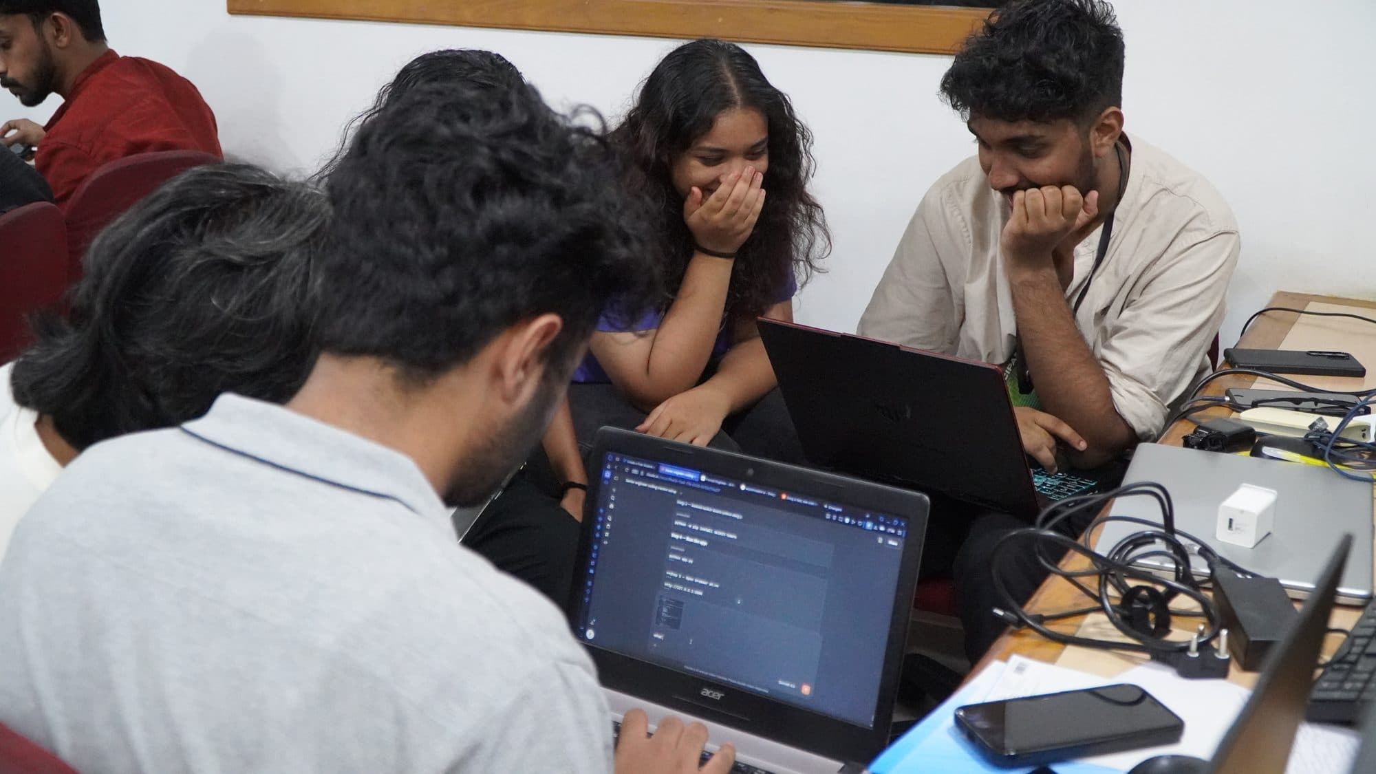 HackFit participants collaborating around laptops