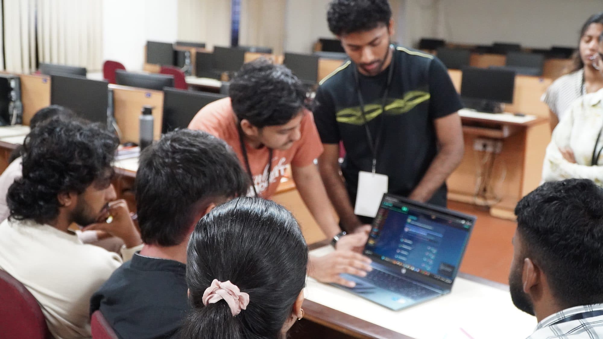 Teams working together on laptops during HackFit