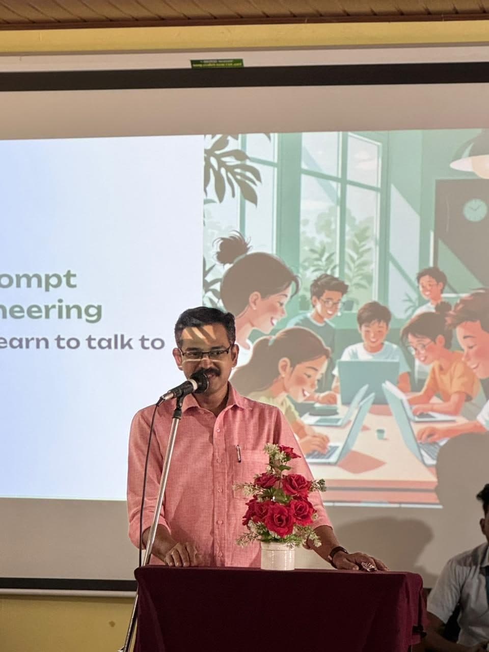 Speaker addressing an Hour of Code session from the stage